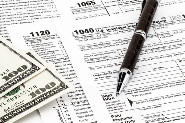 depositphotos 234268046 stock photo tax forms money pen tax (1)